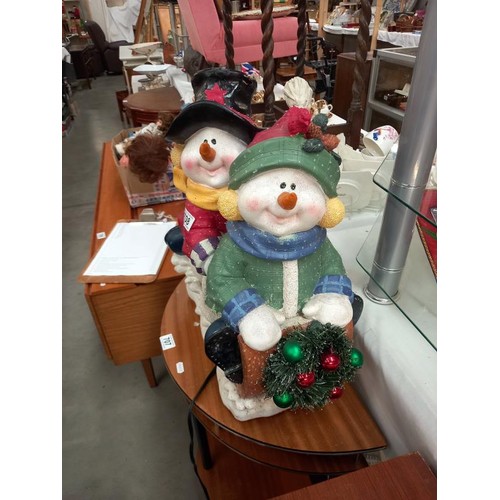 708 - A Christmas decoration of 2 Snowmen figures on a sledge