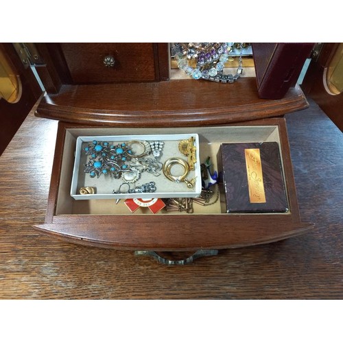 806 - A jewellery box with contents including necklaces, Red Cross items etc.,