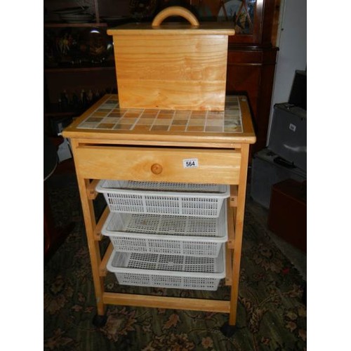 564 - A pine kitchen unit with three baskets and a bread bin.