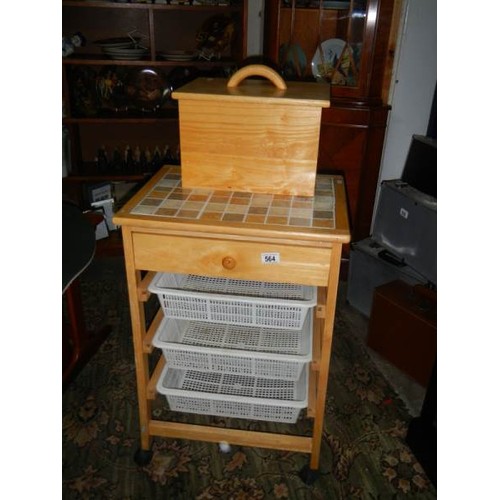 564 - A pine kitchen unit with three baskets and a bread bin.