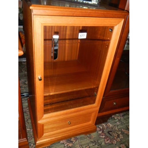 577 - A good quality music cabinet with cut glass door.