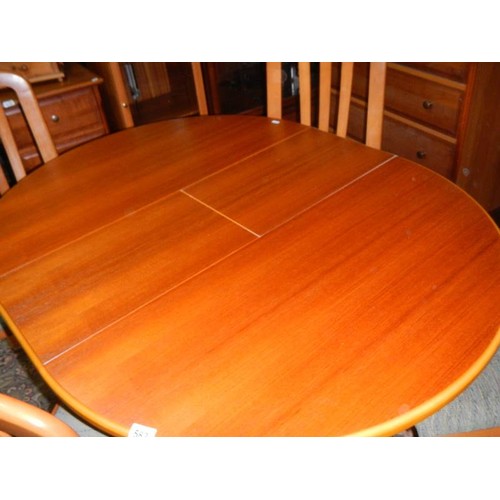 582 - A good clean teak extending dining table with four matching chairs.