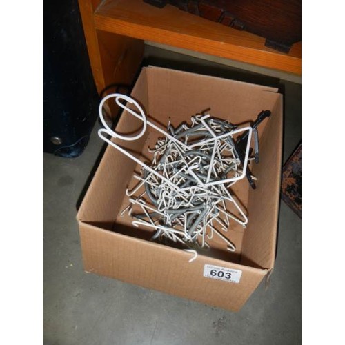 603 - A quantity of plate stands and hangers.