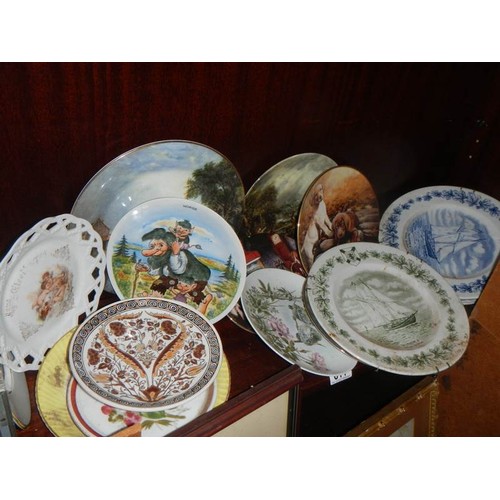 611 - A mixed lot of interesting ceramic plates etc.,