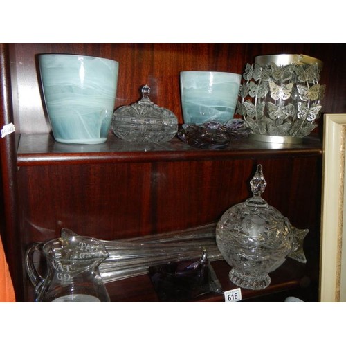 616 - Three tall glass spill vases and other glass ware, two shelves.