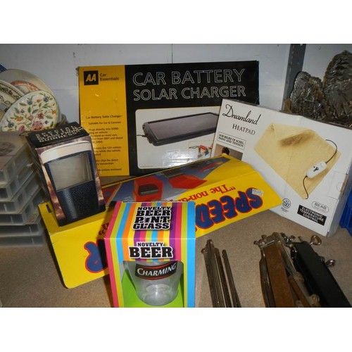 638 - A boxed car battery solar charges and other boxed items.