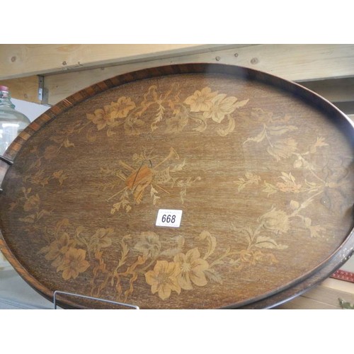 668 - A Victorian oval inlaid tray with brass handles.