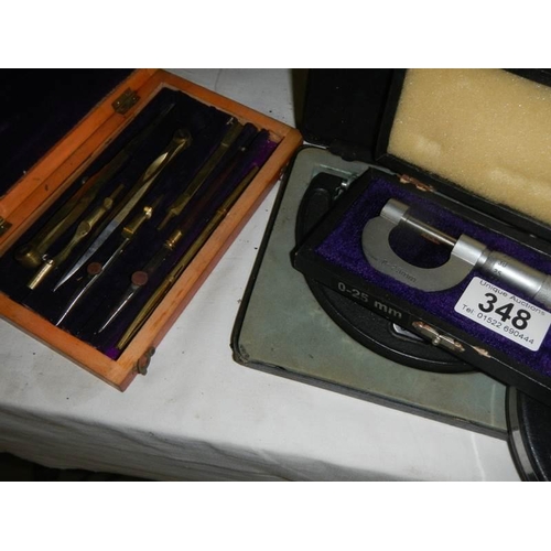 348 - A selection of measuring tools including micrometers and measuring tapes, etc.