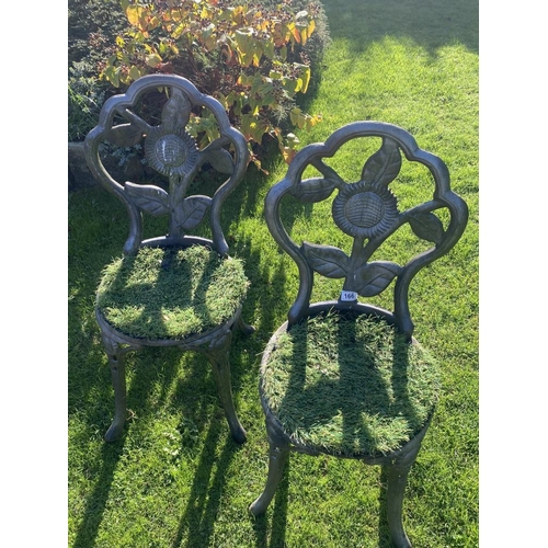 166 - A cast iron garden table with two chairs. Collect Only.