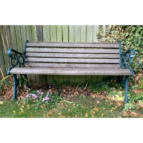 191 - A garden bench, hardwood slats, cast iron ends. Good condition 56 inch long. Collect Only.