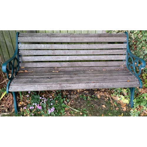 191 - A garden bench, hardwood slats, cast iron ends. Good condition 56 inch long. Collect Only.