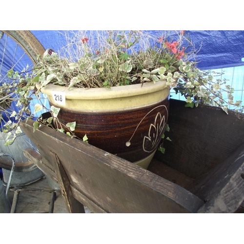 218 - A working ornamental wheel barrow and a potted vine. COLLECT ONLY.