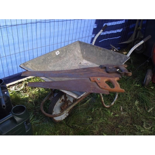 226 - A galvanised wheelbarrow and two saws. COLLECT ONLY.