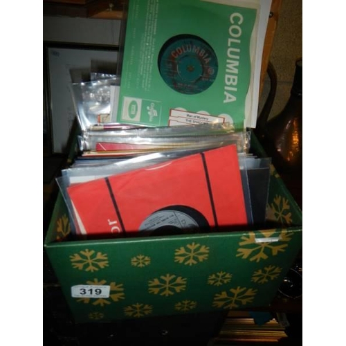 319 - A box of 45 rpm records, Beatles, Hendrix, mostly 1960's.