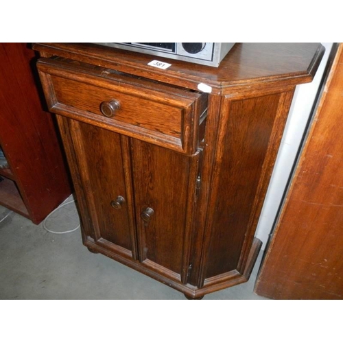 381 - An oak two door cupboard with single drawer. COLLECT ONLY.