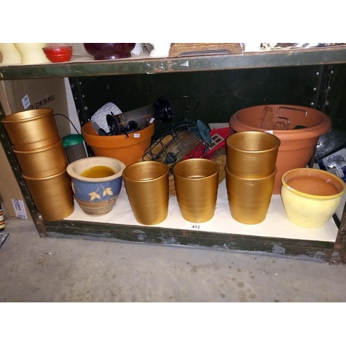 412 - A shelf of plant pots