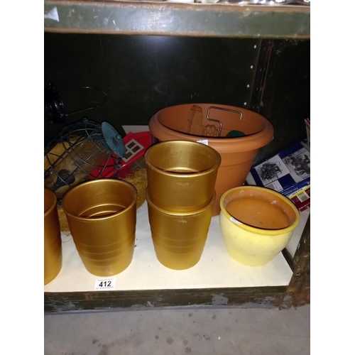 412 - A shelf of plant pots