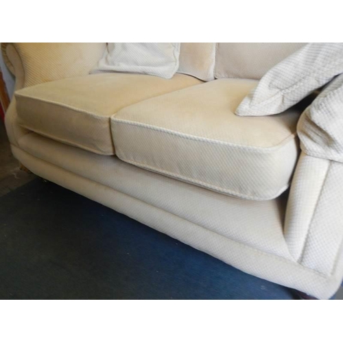 461 - A good two seat sofa on brass castors, COLLECT ONLY,.