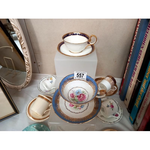 557 - A good assortment of decorative cups and saucers, coffee cans and saucers including Aynsley, Shelley... 