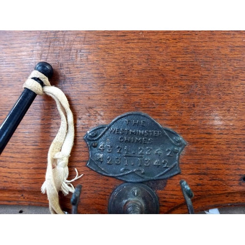 569 - A Victorian oak wall mounted brass bells titled The Westminster chimes with number sequence (bells n... 