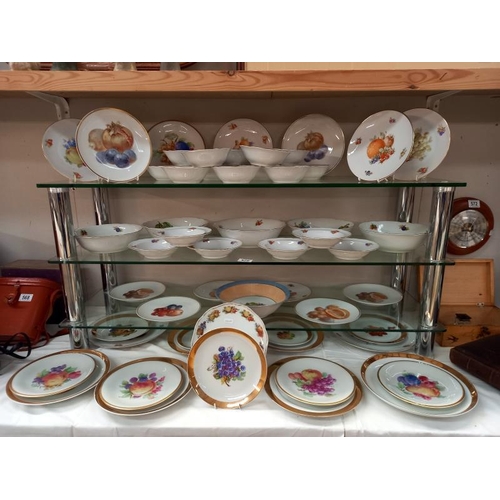 570 - A large lot of plates and dishes depicting fruit