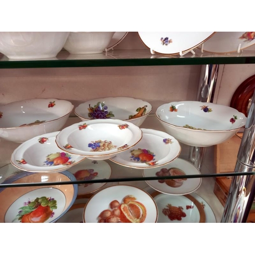 570 - A large lot of plates and dishes depicting fruit