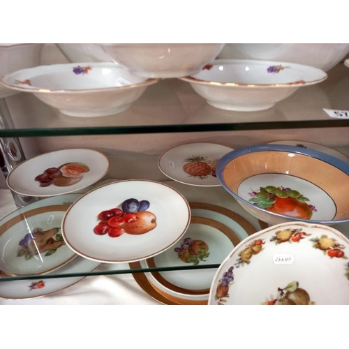 570 - A large lot of plates and dishes depicting fruit