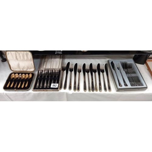 582 - A boxed set of fish knife and forks by Guy Degrenne, boxed cake forks, boxed spoons and a loose set ... 