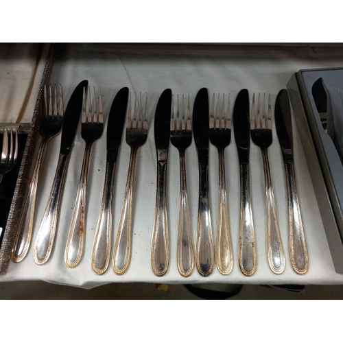 582 - A boxed set of fish knife and forks by Guy Degrenne, boxed cake forks, boxed spoons and a loose set ... 