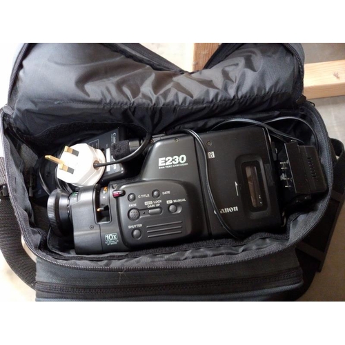 585 - A Canon E230 camcorder, Plustek optic film 7200i scanner and cased tripod