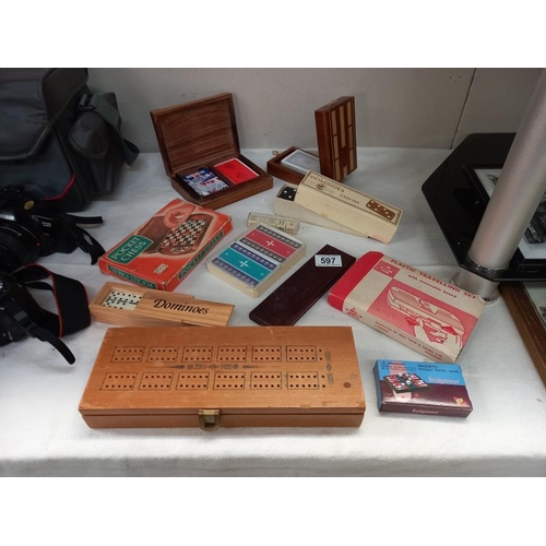 597 - A good lot of games including cribbage, cards, dominoes, draughts and chess travelling set, poker di... 