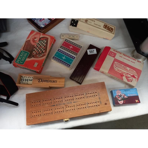 597 - A good lot of games including cribbage, cards, dominoes, draughts and chess travelling set, poker di... 