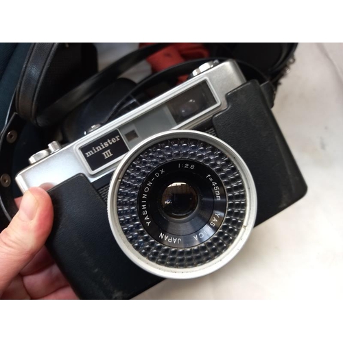 607 - A vintage Canon camera and a Yashica camera in carry case