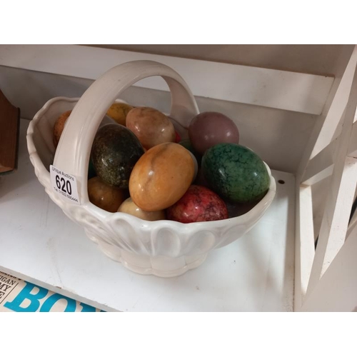 620 - A quantity of polished stone eggs in china basket