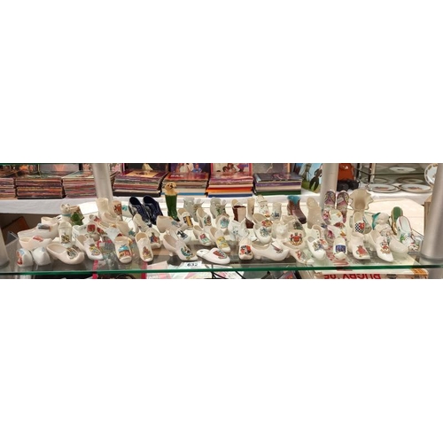 632 - A large selection of crested ware shoe ornaments