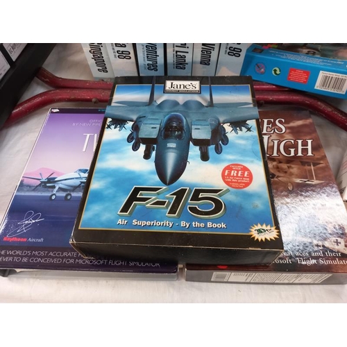 654 - A quantity of boxed Microsoft flight simulator games and 2 keyboards