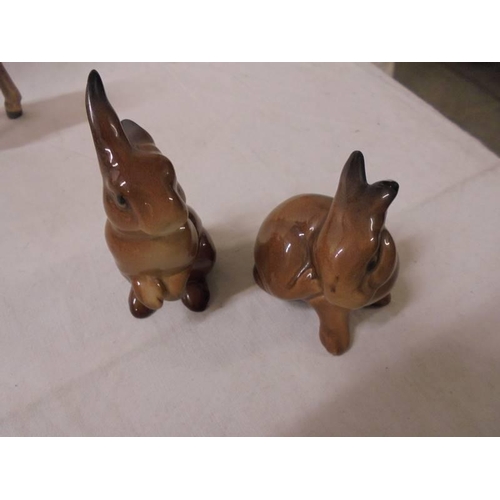 1214 - A Beswick donkey, calf and two rabbits.