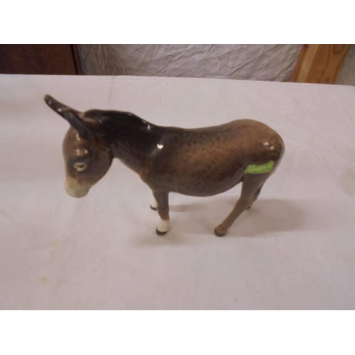 1214 - A Beswick donkey, calf and two rabbits.