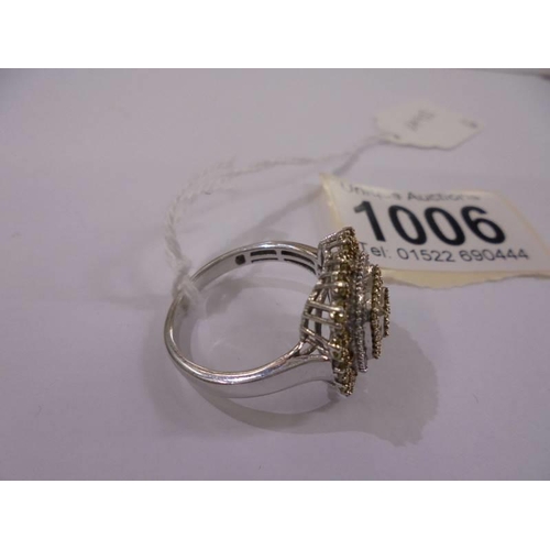 1006 - A silver ring set diamonds, size V.