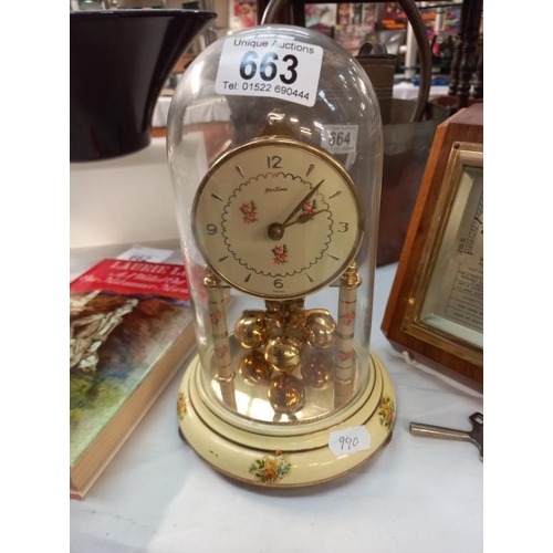 663 - A Bentima floral pattern anniversary clock under glass dome and a vintage barometer.