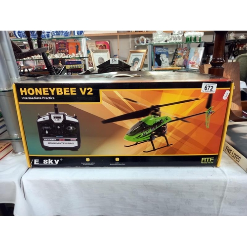 672 - A boxed E Sky honey bee V2 RC helicopter. Looks complete, untested/ unchecked.