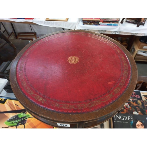 674 - An Edwardian style drum table with gilded red leather top. Diameter 51cm, Height 55cm.