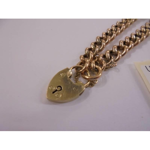 1013 - A 9ct gold bracelet with padlock and safety chain, 10 grams.