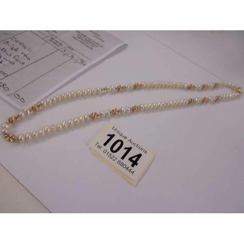 1014 - A single row cultured pearl and gold necklace with original purchase receipt for 1994.