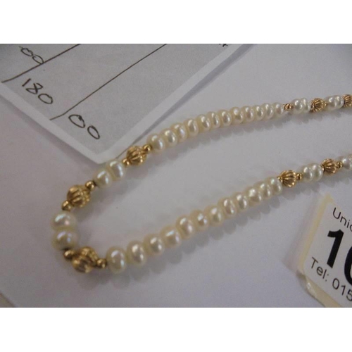 1014 - A single row cultured pearl and gold necklace with original purchase receipt for 1994.