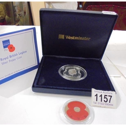 1157 - A cased 'The Royal British Legion' silver poppy coin and one other.