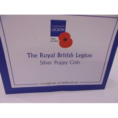 1157 - A cased 'The Royal British Legion' silver poppy coin and one other.