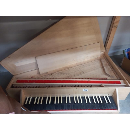 714 - A wooden harpsichord, case and three books. Collect Only. Harpsichord in the case needs attention, s... 