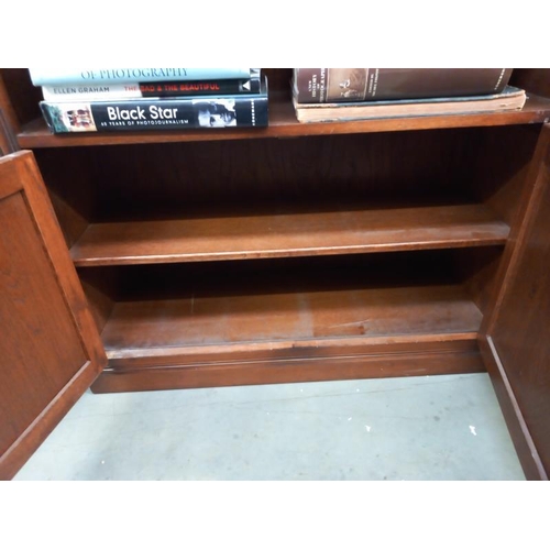 747 - A dark oak bookcase with linen fold cupboard doors 92cm x 33cm x height 153cm