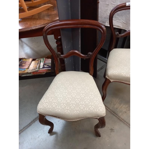 752 - A pair of Victorian balloon back chairs